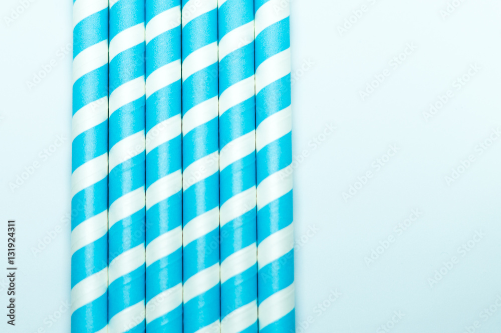 Baby blue striped straws. Party background. Baby blue striped straws. Party background.