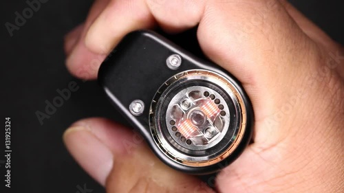 test burning the new dual kanthal micro coils on the atomizer deck base of electronic cigarette for vaping, close up scene, high definition, Full HD, 1920x1080
