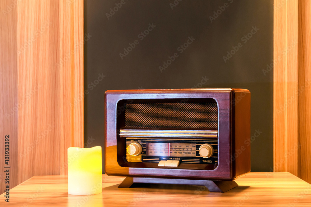 Vintage radio set. Old-fashioned wooden radio set and a yellow candle on a  table. Stock Photo | Adobe Stock