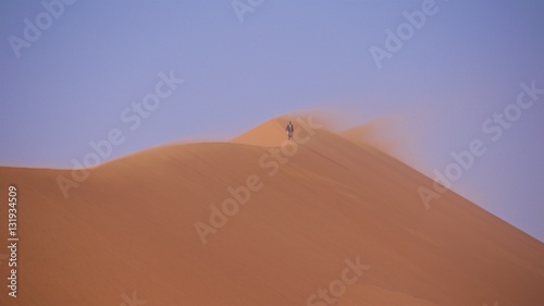 Walking on top of the sand dune of Big Daddy in Namib-Naukluft National Park, Namibia
