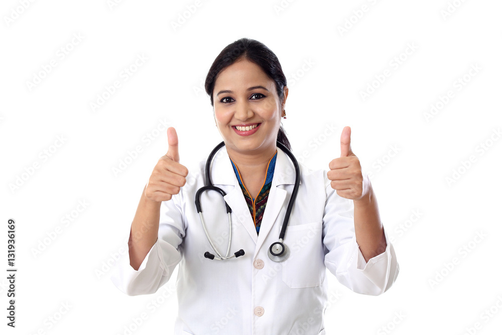 Successful Indian woman doctor showing thumbs up Successful Indian woman doctor showing thumbs up