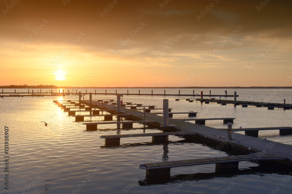 Naklejka premium Yacht port over orange sunset