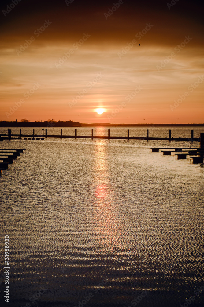 Yacht port over orange sunset