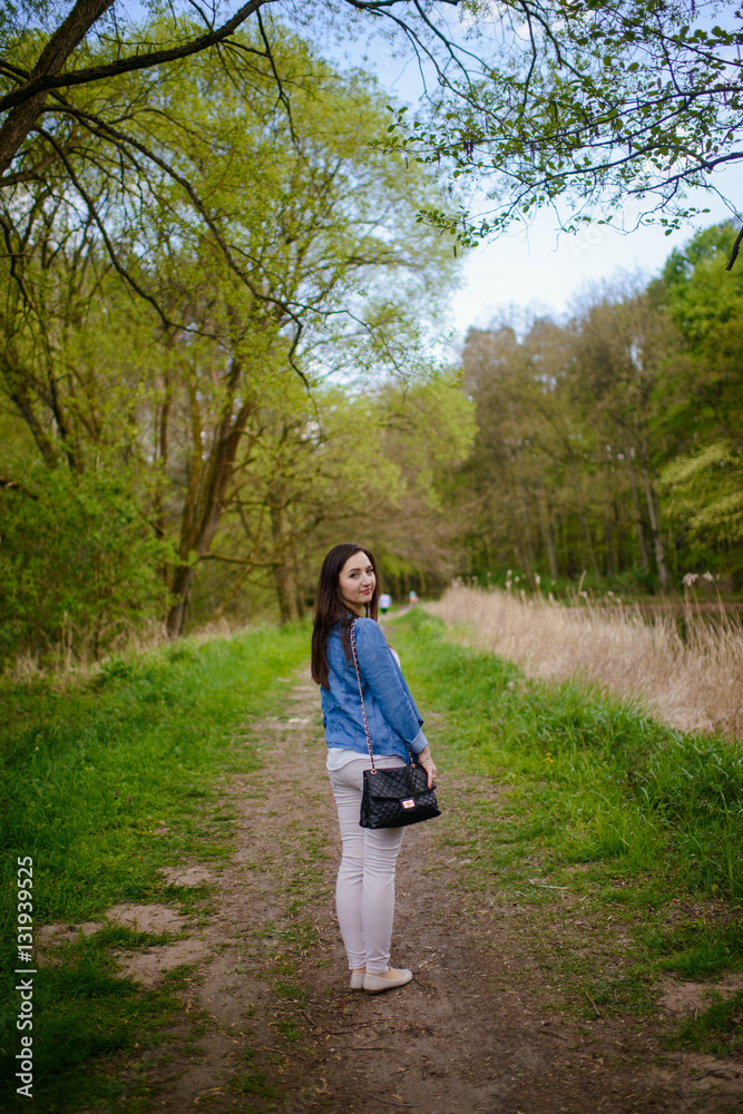 Fototapeta premium Young girl on a walk in the forest