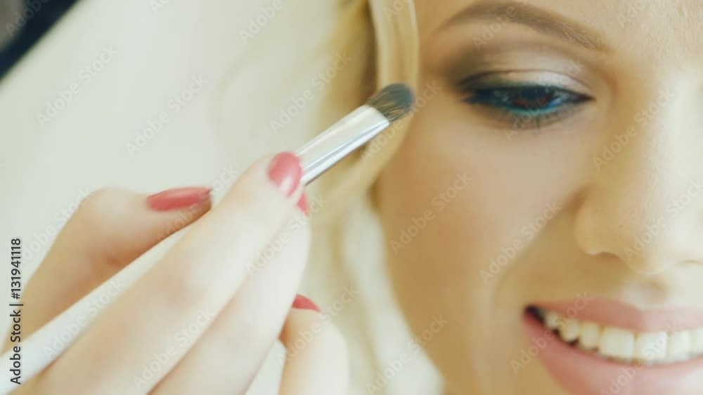 Attractive Caucasian bride applied makeup on the eyes. Smiling, happy wedding day Attractive Caucasian bride applied makeup on the eyes. Smiling, happy wedding day