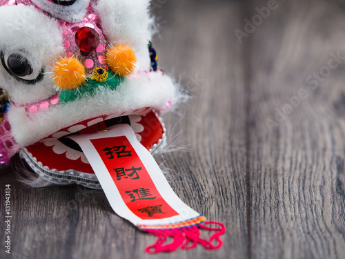 Chinese new year decoration lion on plank wooden board photo