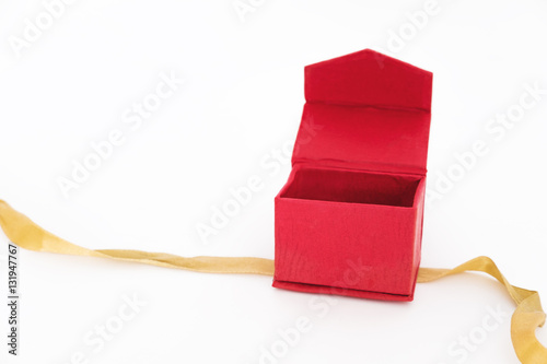 Red box opened with bolden ribbon, isolated on white background photo