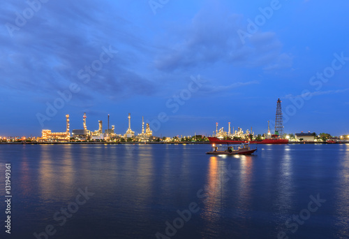 Oil refinery on water front at twilight