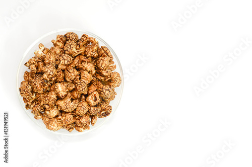 Top view of chocolate popcorn in glass bowl on white background
