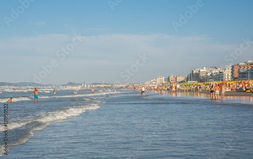 Time lapse on Riccione promenade during sunset. Rows of sun umbrellas. Emilia Romagna. Italy photo