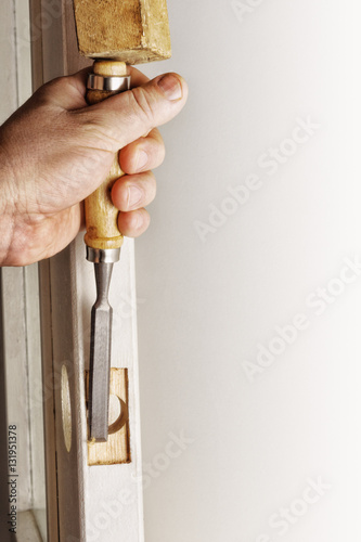 Making the slot in the door  with a chisel.