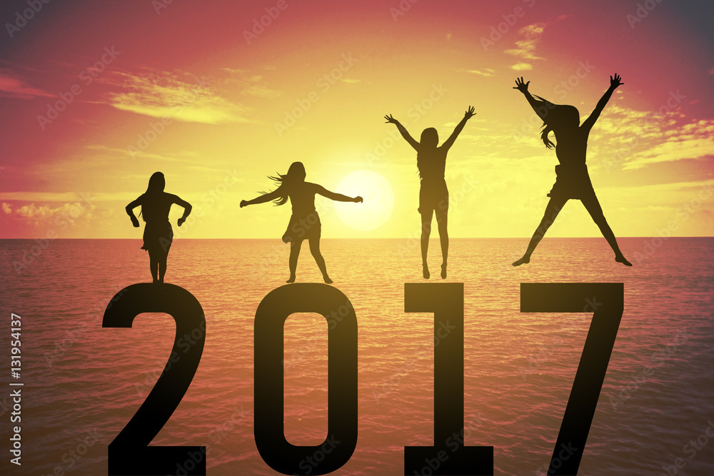 Silhouette young woman jumping and raising up her hand about happy concept on numbers 2017 over a beautiful sunset or sunrise at the sea, background for happy news years.success in 2017 years Silhouette young woman jumping and raising up her hand about happy concept on numbers 2017 over a beautiful sunset or sunrise at the sea, background for happy news years.success in 2017 years