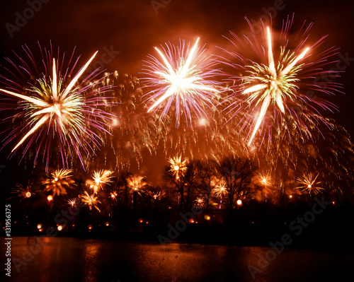 Abstract  blurry  bokeh-style colorful photo of fireworks above the river in New Year