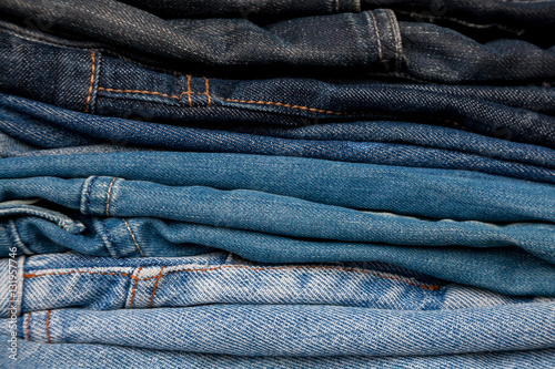 Stack of jeans fashion Background different denim layers colors