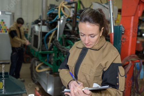 woman engineer with clipboard in factory
