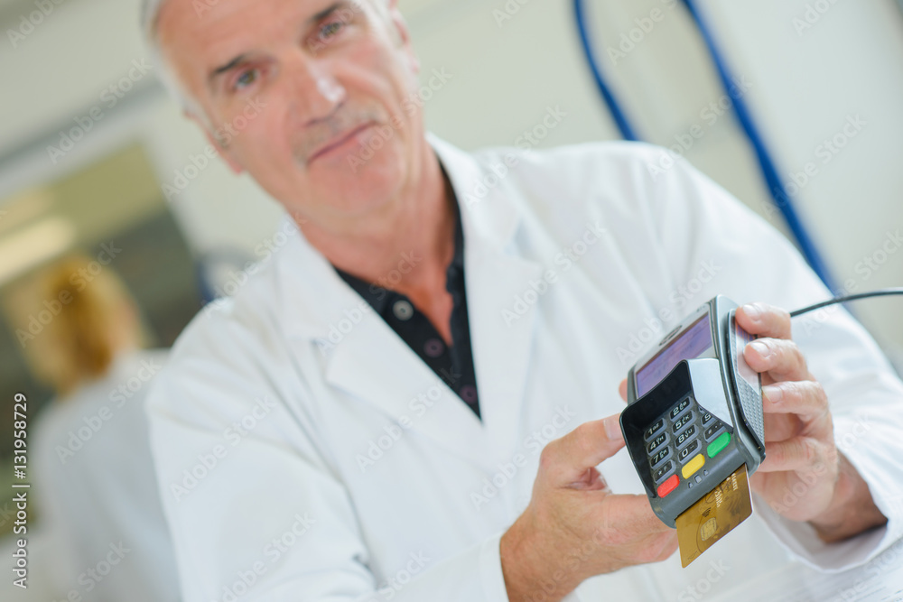 Worker holding card payment machine Worker holding card payment machine