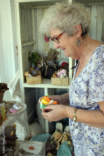 Lady of Senior Age Examining Products in a Crafts Shop