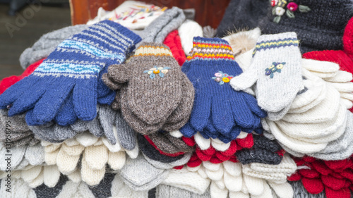 Group of handmade colorful knitted socks, mittens, gloves and hats in the market.