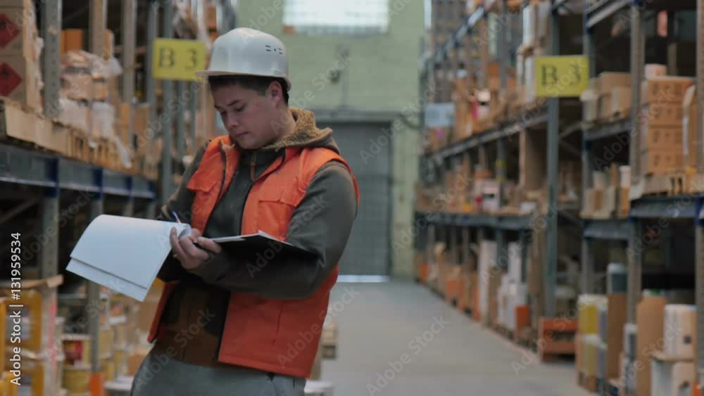 An Employee at the Warehouse Keeps Track An Employee at the Warehouse Keeps Track