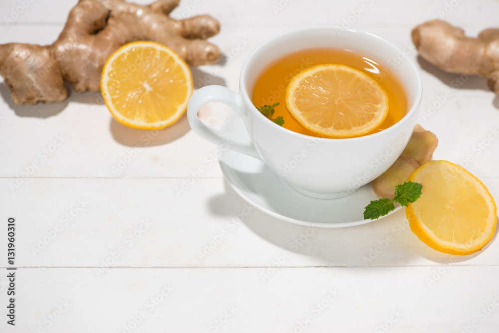 Cup of Ginger Tea with Lemon and Honey on a White Wooden Backgro Cup of Ginger Tea with Lemon and Honey on a White Wooden Backgro