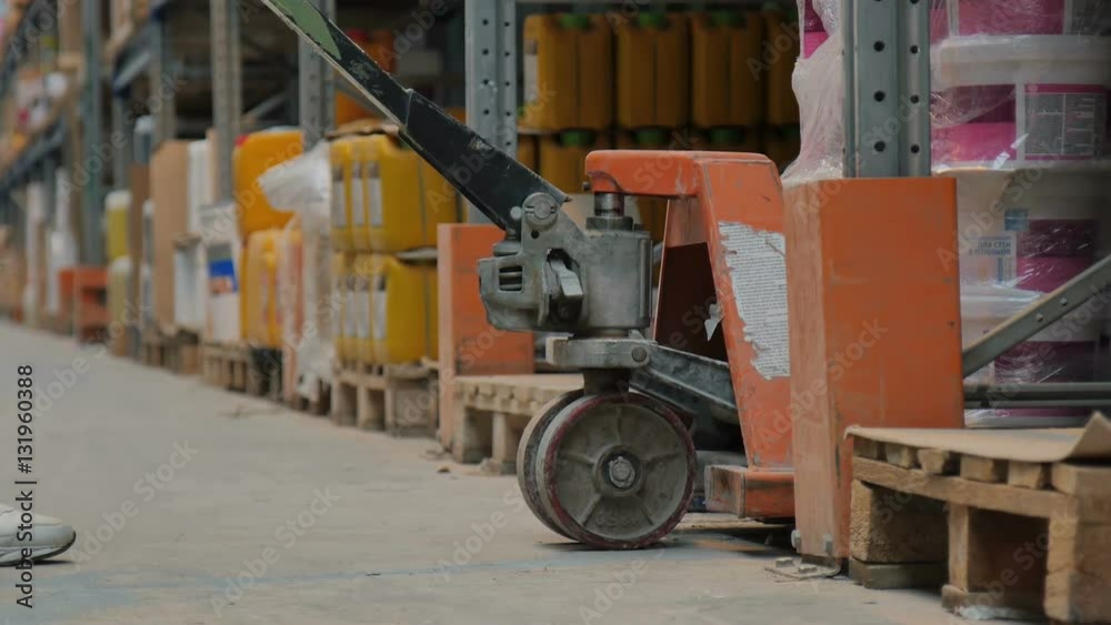 Warehouse Worker Raises Goods