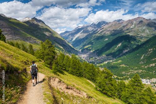 Girl walking on spectacular mountain scenery, Alps, Switzerland.