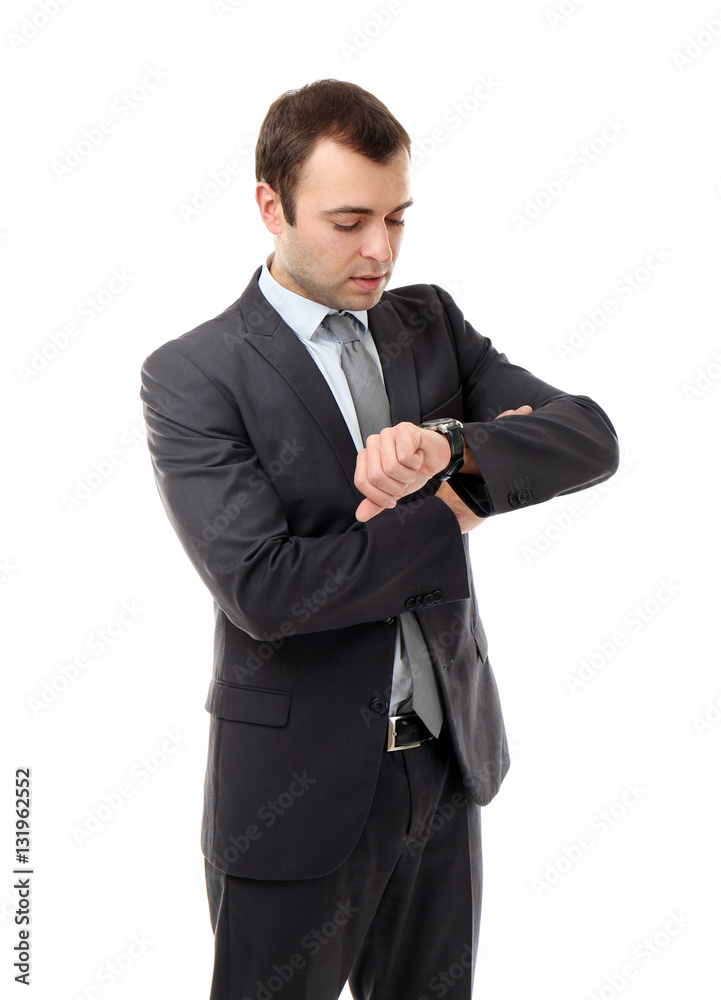 Handsome businessman looking at his watch, on white background Handsome businessman looking at his watch, on white background