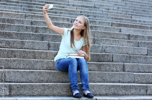 Pretty teenager girl taking...