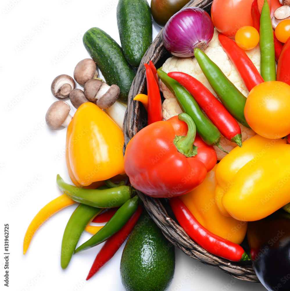 Group of fresh vegetables in basket on white background