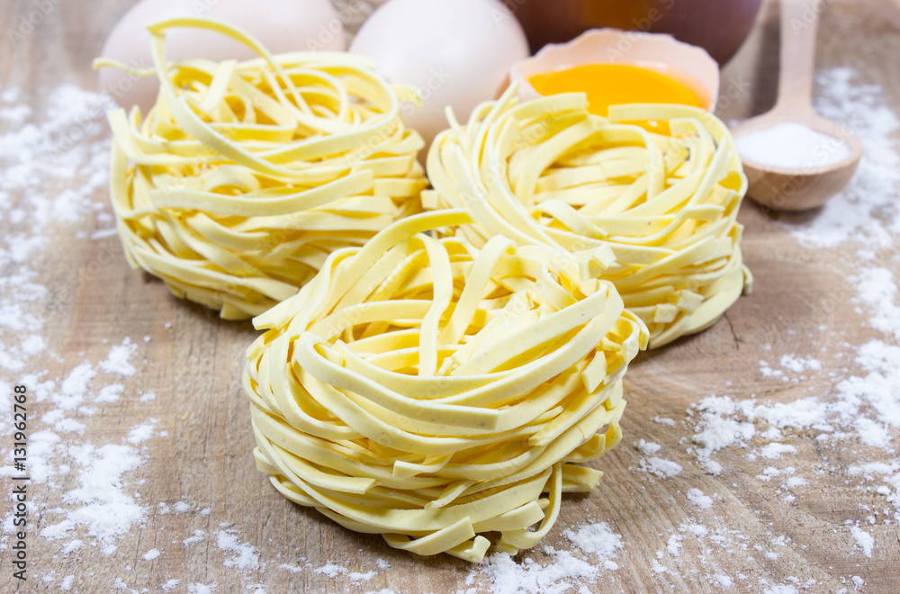 Raw homemade pasta and ingredients for pasta. Raw homemade pasta and ingredients for pasta.