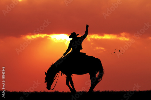 cowboy rodeo silhouette at sunset