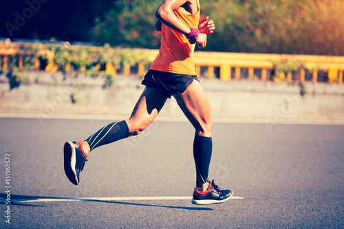 fitness male marathon runner running on city road