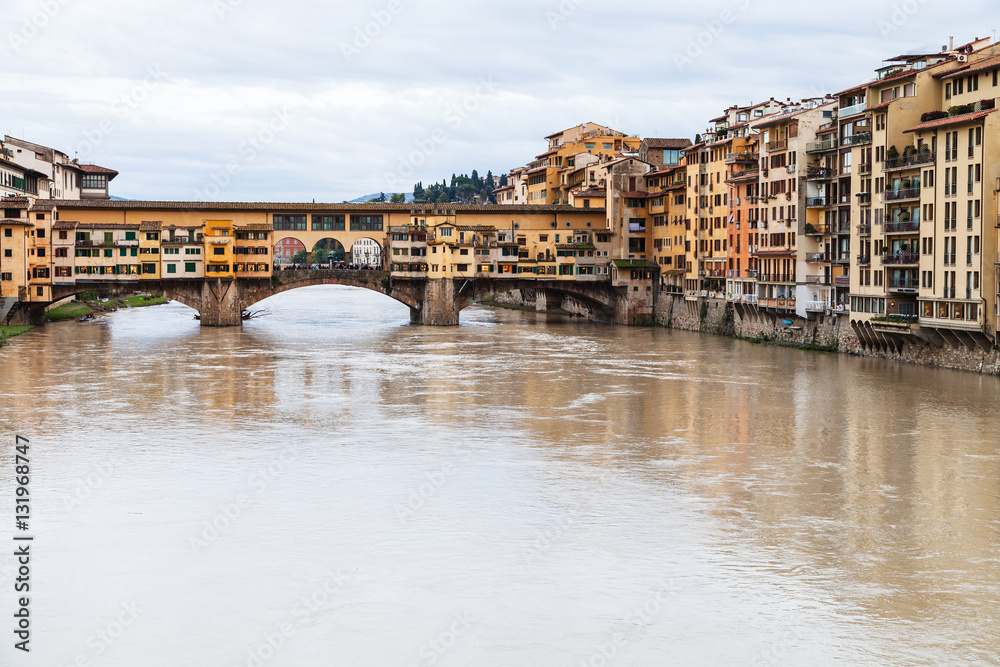 Ponte Vecchio over Arno River and houses in autumn
