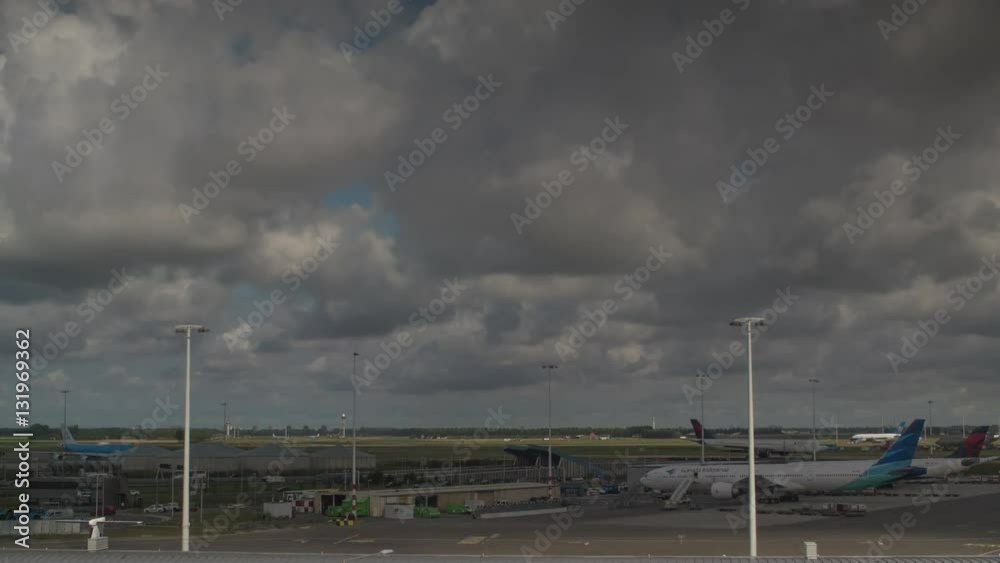 AMSTERDAM, NETHERLANDS - AUGUST 04, 2016: Timelapse shot of clouds sailing over Amsterdam Airport Schiphol, the main international airport of the Netherlands, AMSTERDAM, NETHERLANDS - AUGUST 04, 2016: Timelapse shot of clouds sailing over Amsterdam Airport Schiphol, the main international airport of the Netherlands,