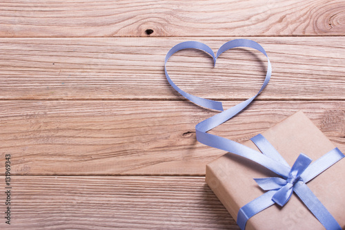 Gift box of kraft paper with a ribbon in the shape of heart