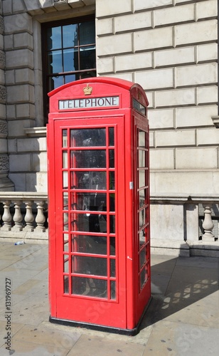 A vintage red telephone kiosk in London.  