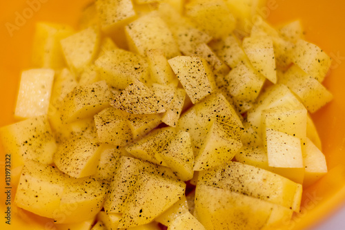 Cut raw potatoes in bowl
