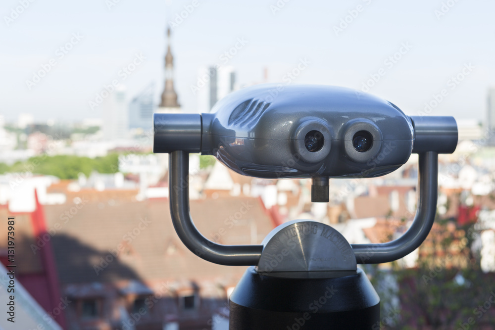 High spy viewing machine and cityscape backdrop