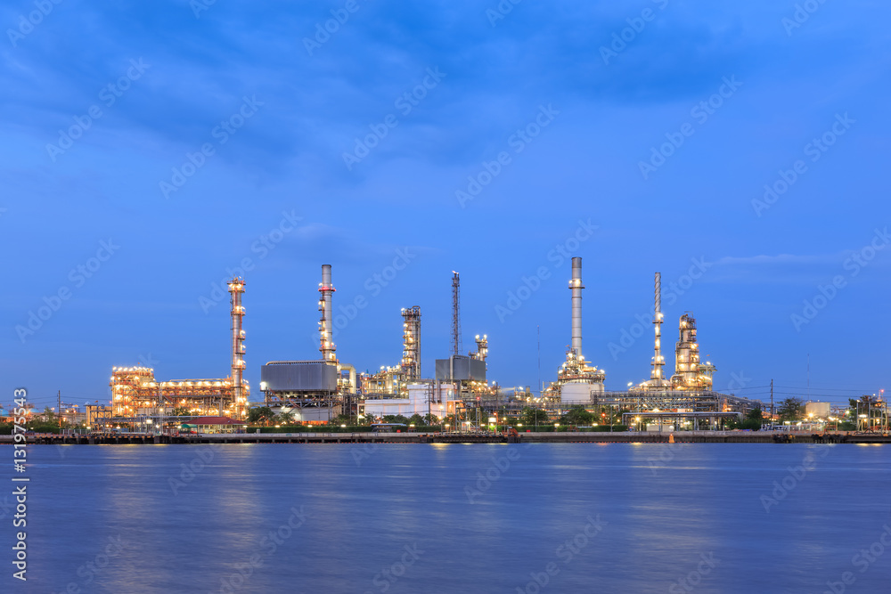 Oil refinery on water front at twilight