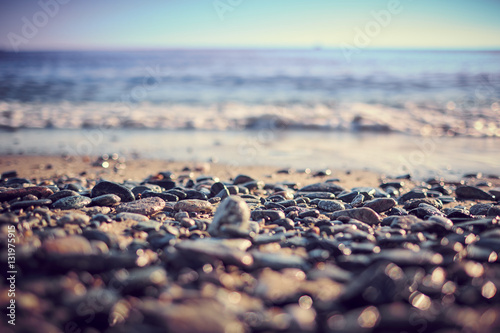Spiaggia ligure con ciottoli e sabbia all'alba photo