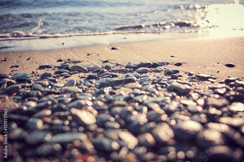 Spiaggia ligure con ciottoli e sabbia all'alba photo