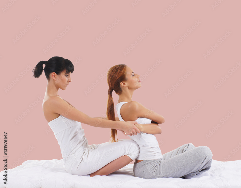 Woman on a Thai massage on a pink background Woman on a Thai massage on a pink background