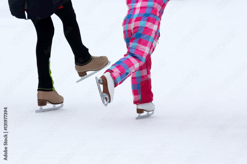 children skate on the ice rink children skate on the ice rink