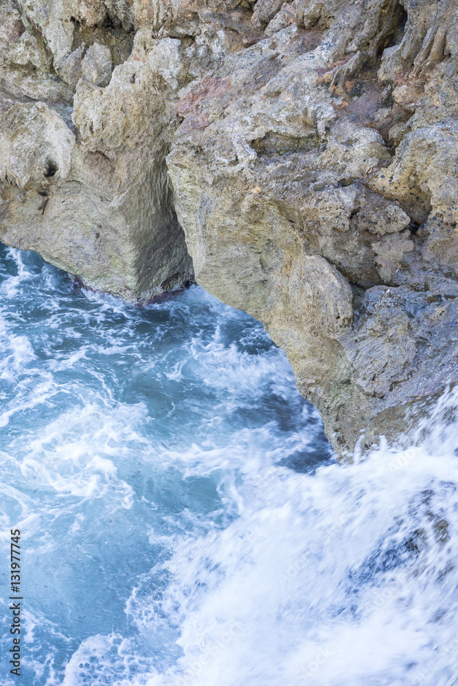 Cliff, Rocks by the sea with waves of the Mediterranean sea next Cliff, Rocks by the sea with waves of the Mediterranean sea next