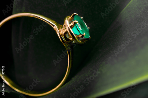 gold ring with an emerald on leaf