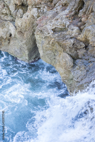 Cliff  Rocks by the sea with waves of the Mediterranean sea next
