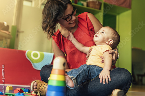 Child boy and mother playing. photo