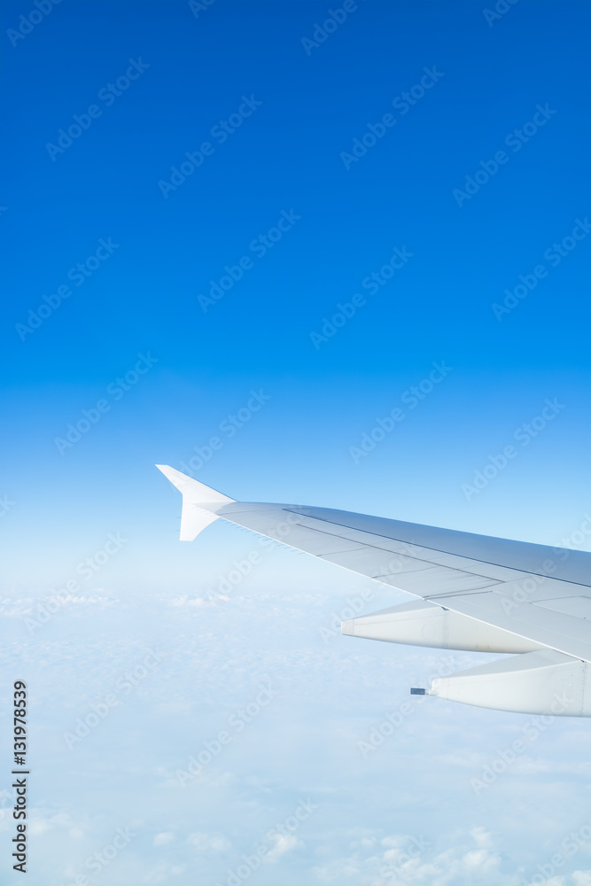 Obraz premium Airplane wing above cloud seen through window