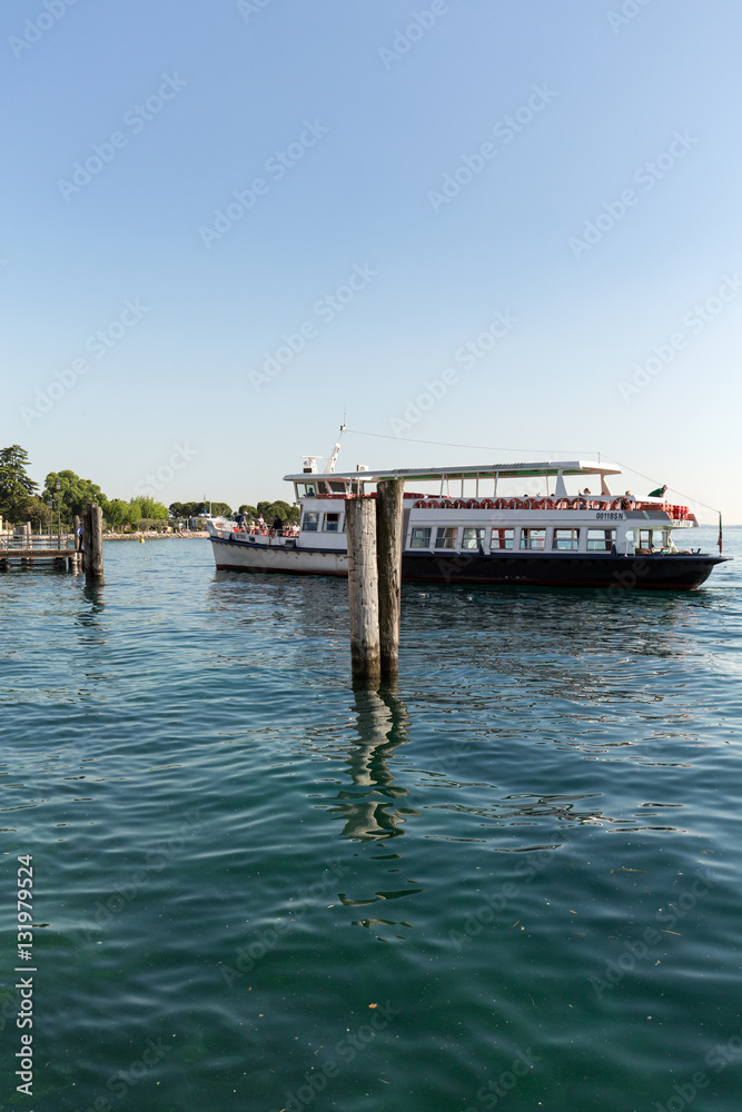 Fototapeta premium Sailboats and fishing boats at Porto di Bardolino harbor on The Garda Lake . Italy