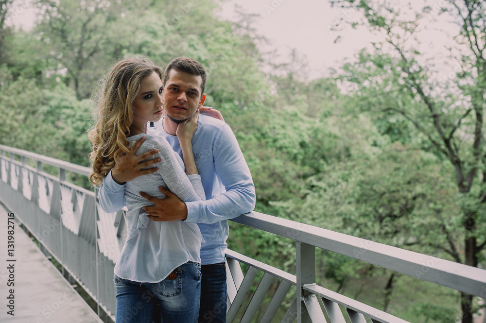 Beautiful young couple playing in a park. Summer outdoors. Beautiful young couple playing in a park. Summer outdoors.